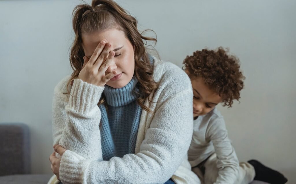 tired mother with black boy - this highlights the need for self compassion for parents