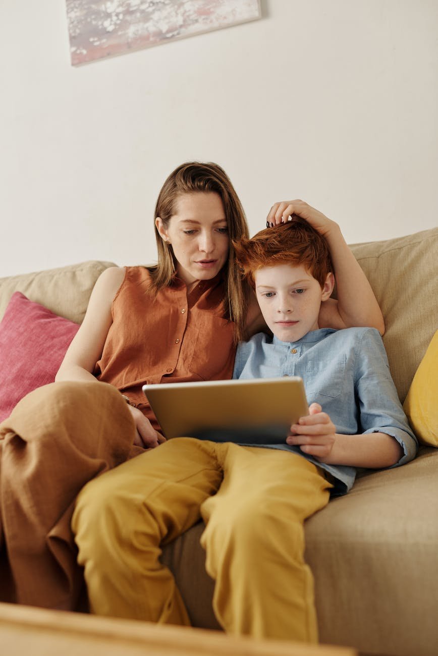 photo of woman and boy watching through tablet computer -radical acceptance