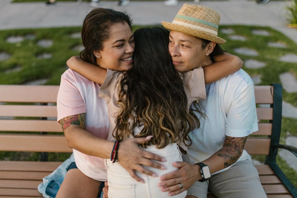 a young girl hugging her parents