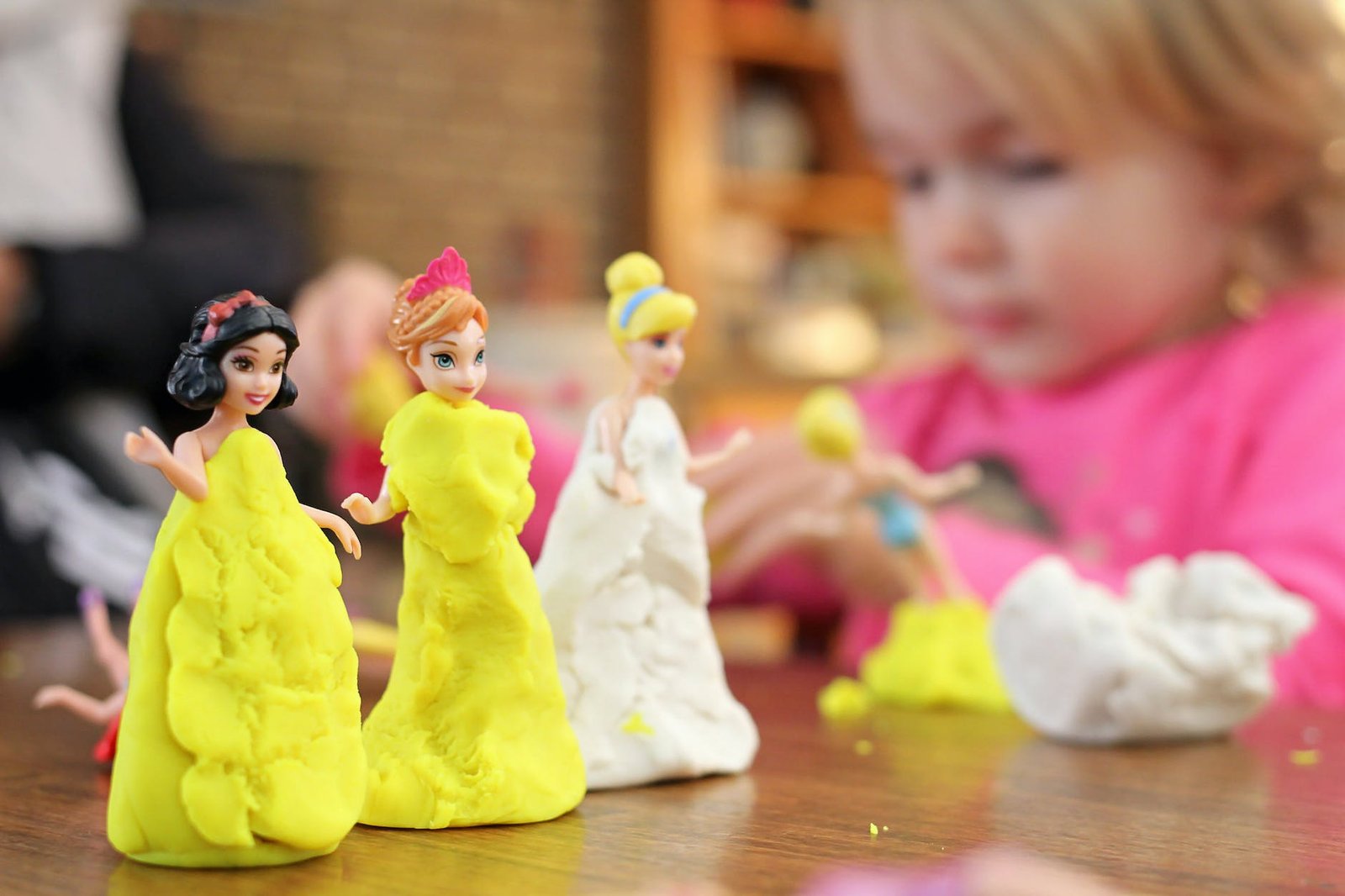 selective focus photography of three disney princesses figurines on brown surface - Autistic and ADHD play in early childhood.