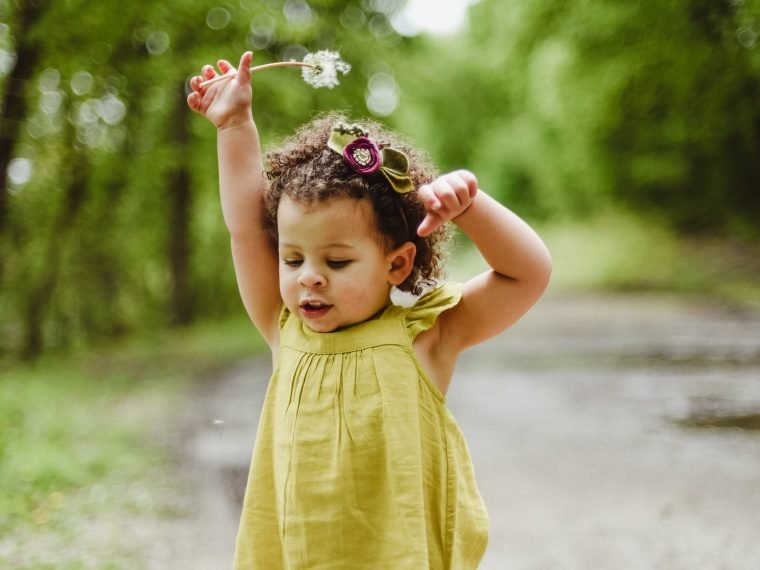 baby wearing green dress o