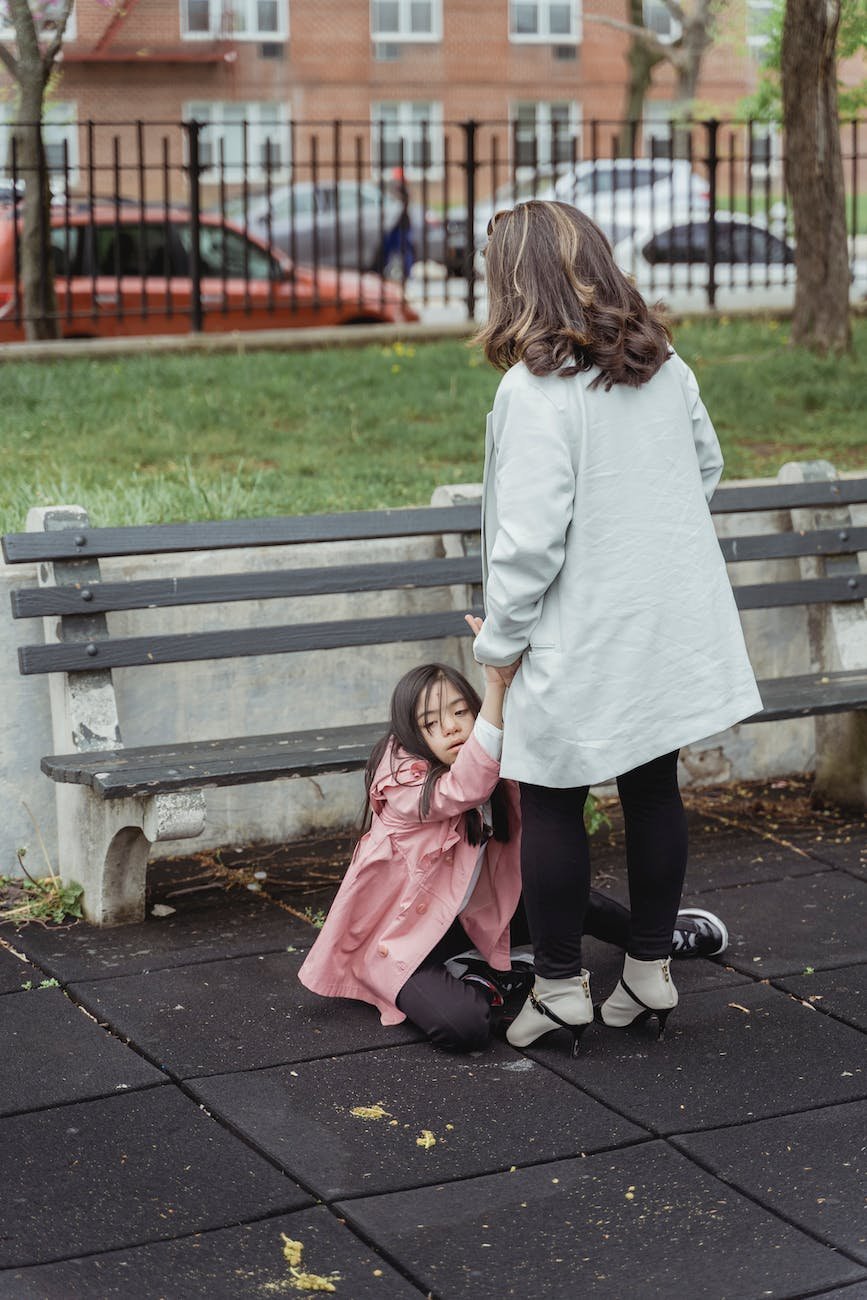 a woman holding a young girl while sitting on the ground Autistic and ADHD Girls In Early Childhood