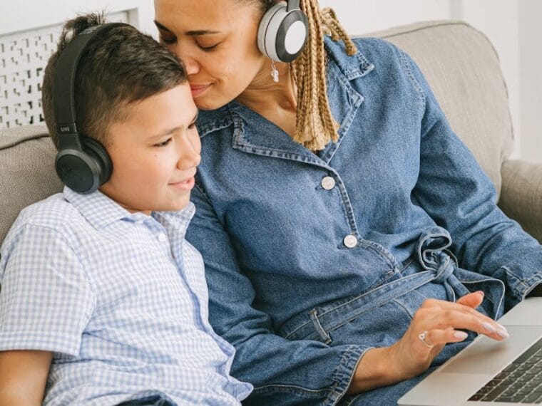 man in blue button up shirt and blue denim shorts using macbook