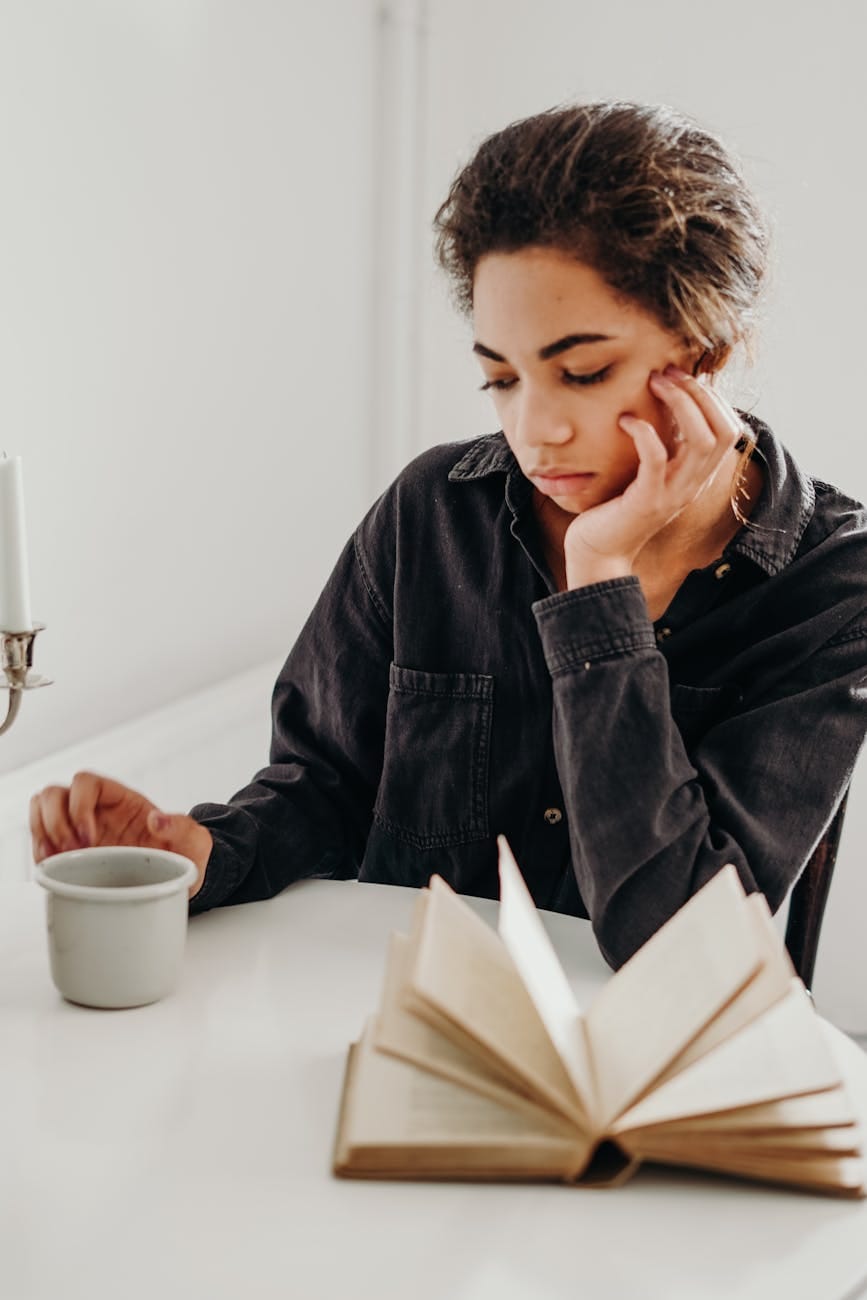 woman looking on ceramic cup of coffee - self-care for mothers of neurodivergent children