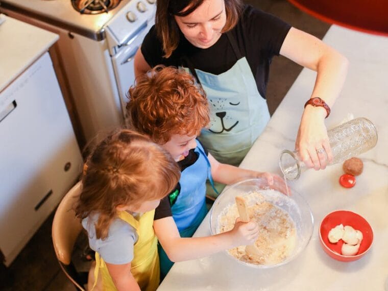 top view of a mom baking with her kids in a kitchen
