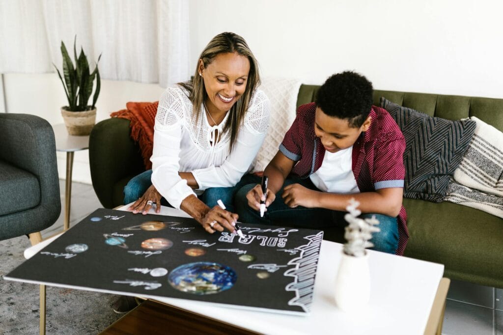 woman and boy doing a poster together