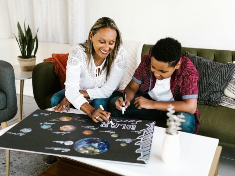 woman and boy doing a poster together
