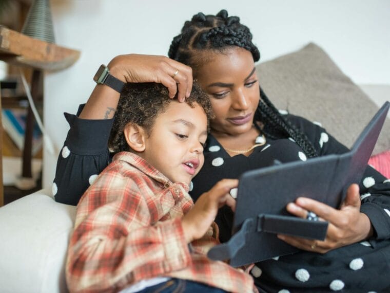 Mother and son watching something on a tablet together