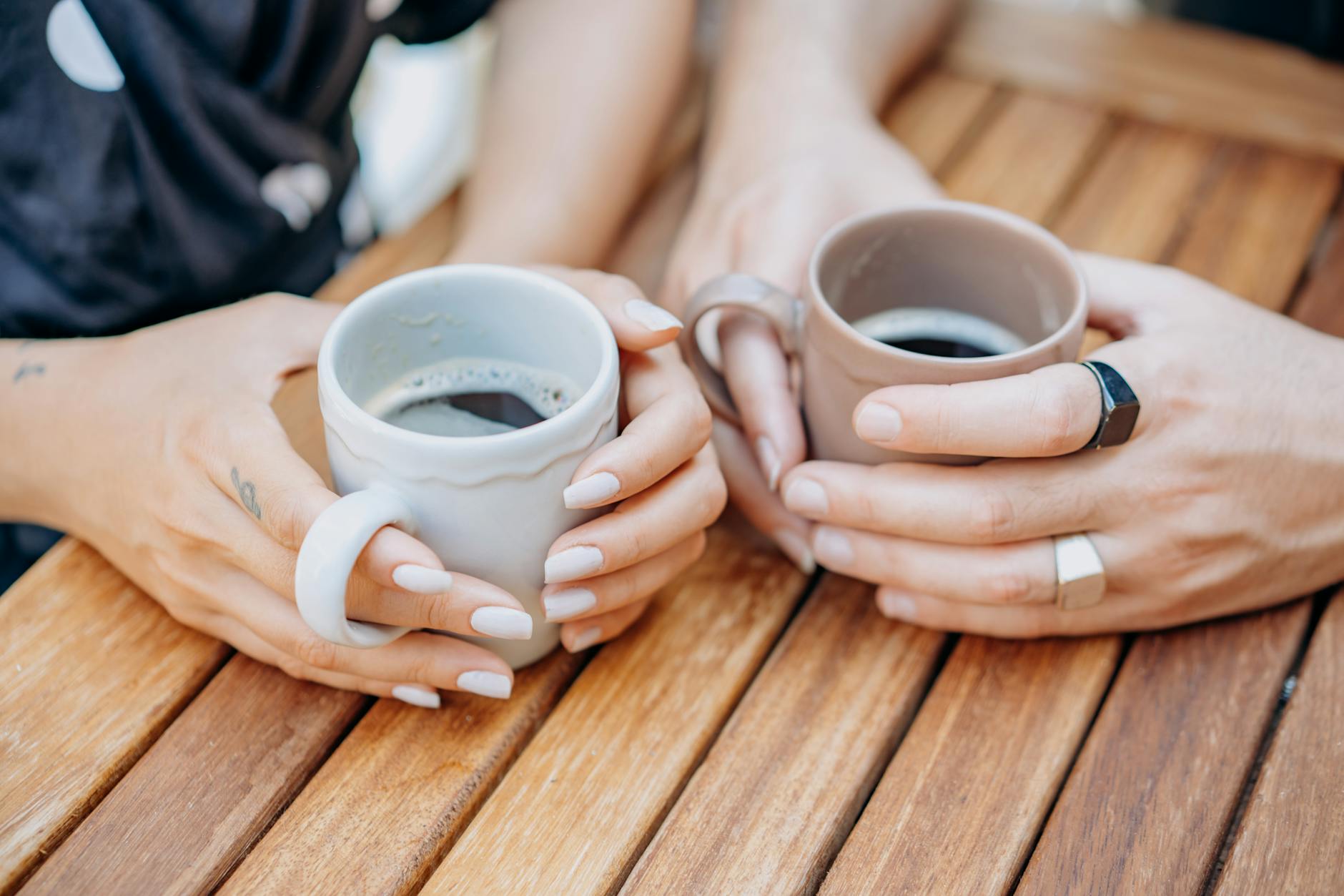 high angle view of two people drinking cups of coffee - Neurodivergent Mothers burnout isolation