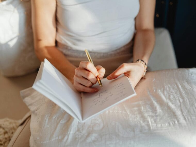 woman writing on a notebook