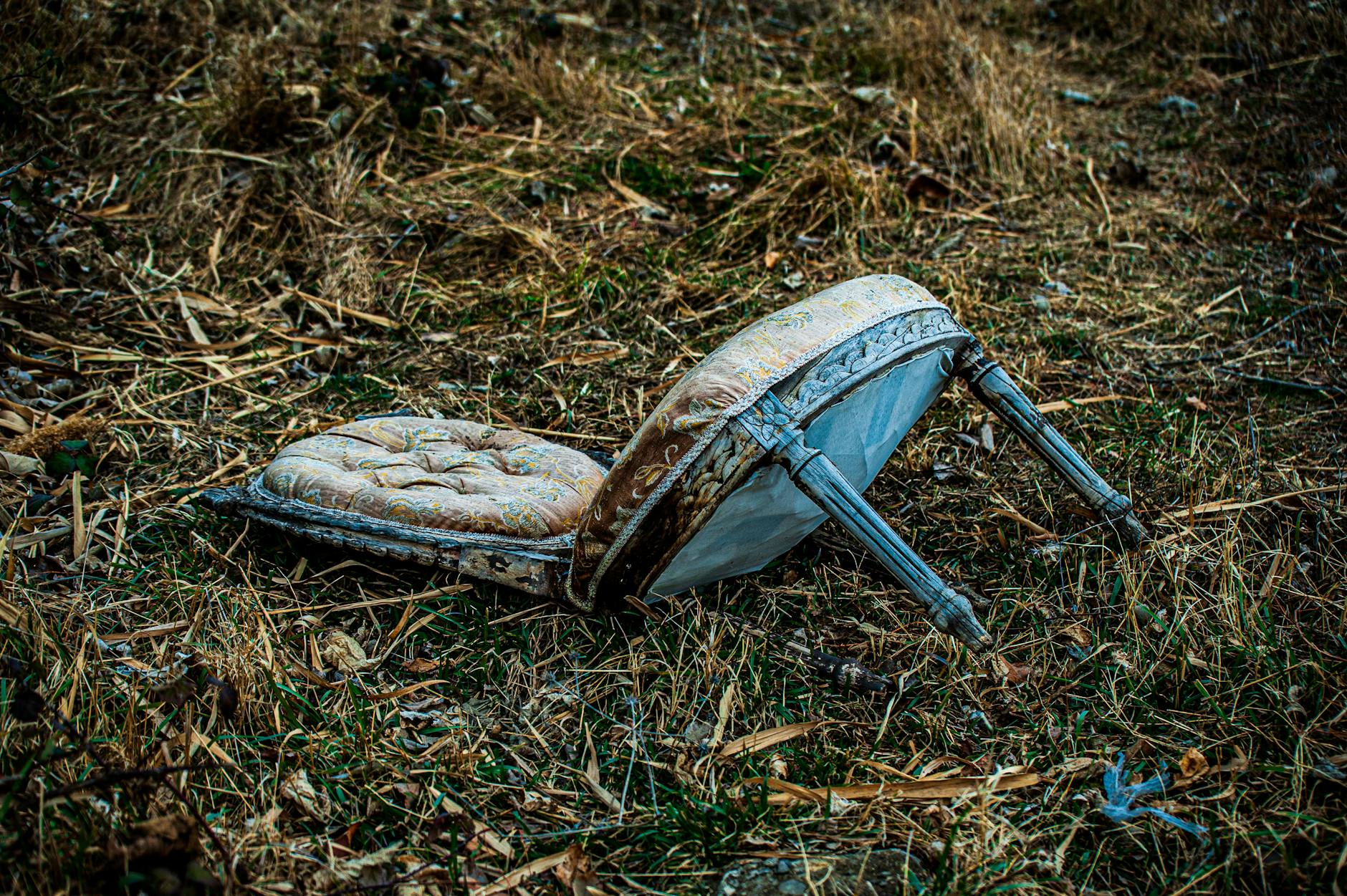 abandoned vintage chair on dry grass field - relational safety autistic burnout