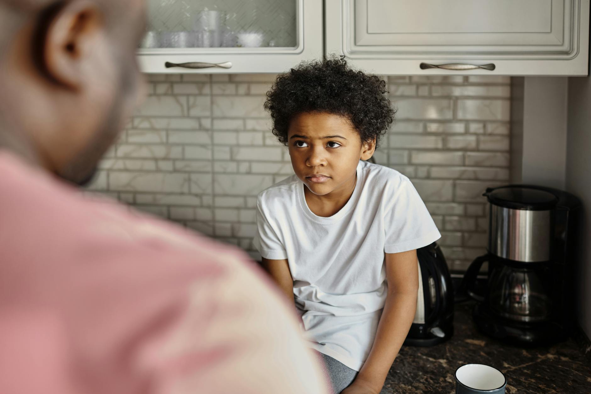 little boy looking at his father - how autistic masking relates to burnout and relational safety