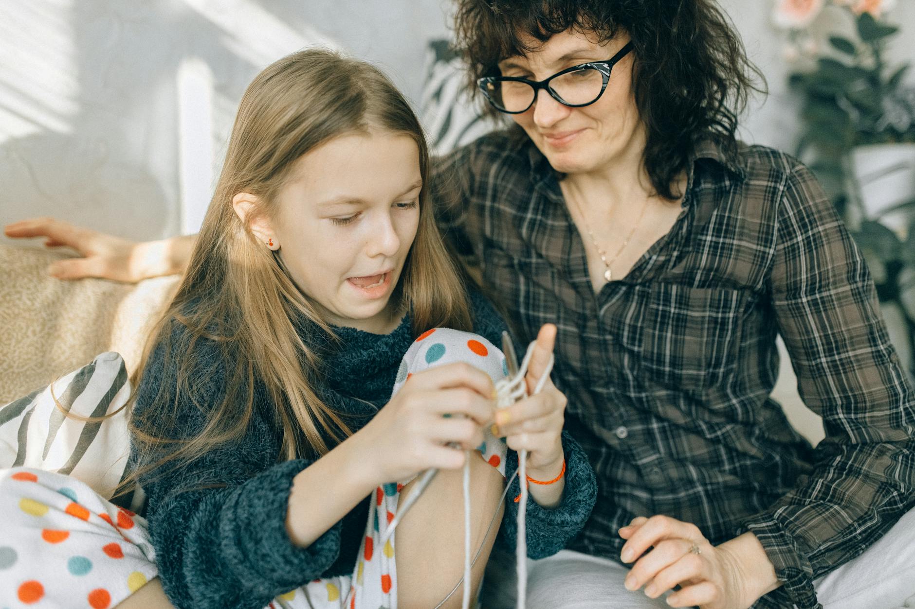mother watching her daughter how to crochet - relational safety autistic burnout