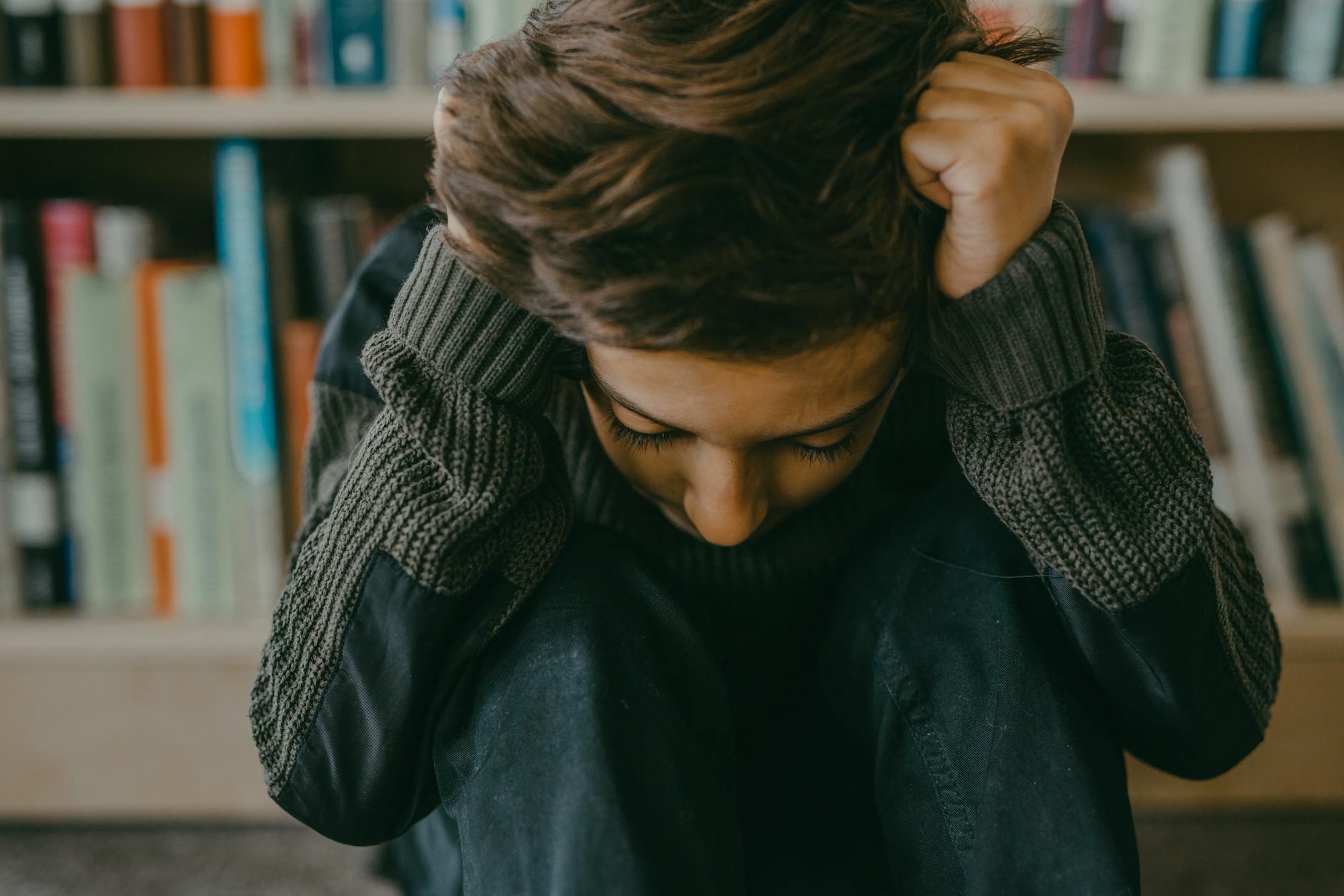 a boy holding his hair - relational safety autistic burnout