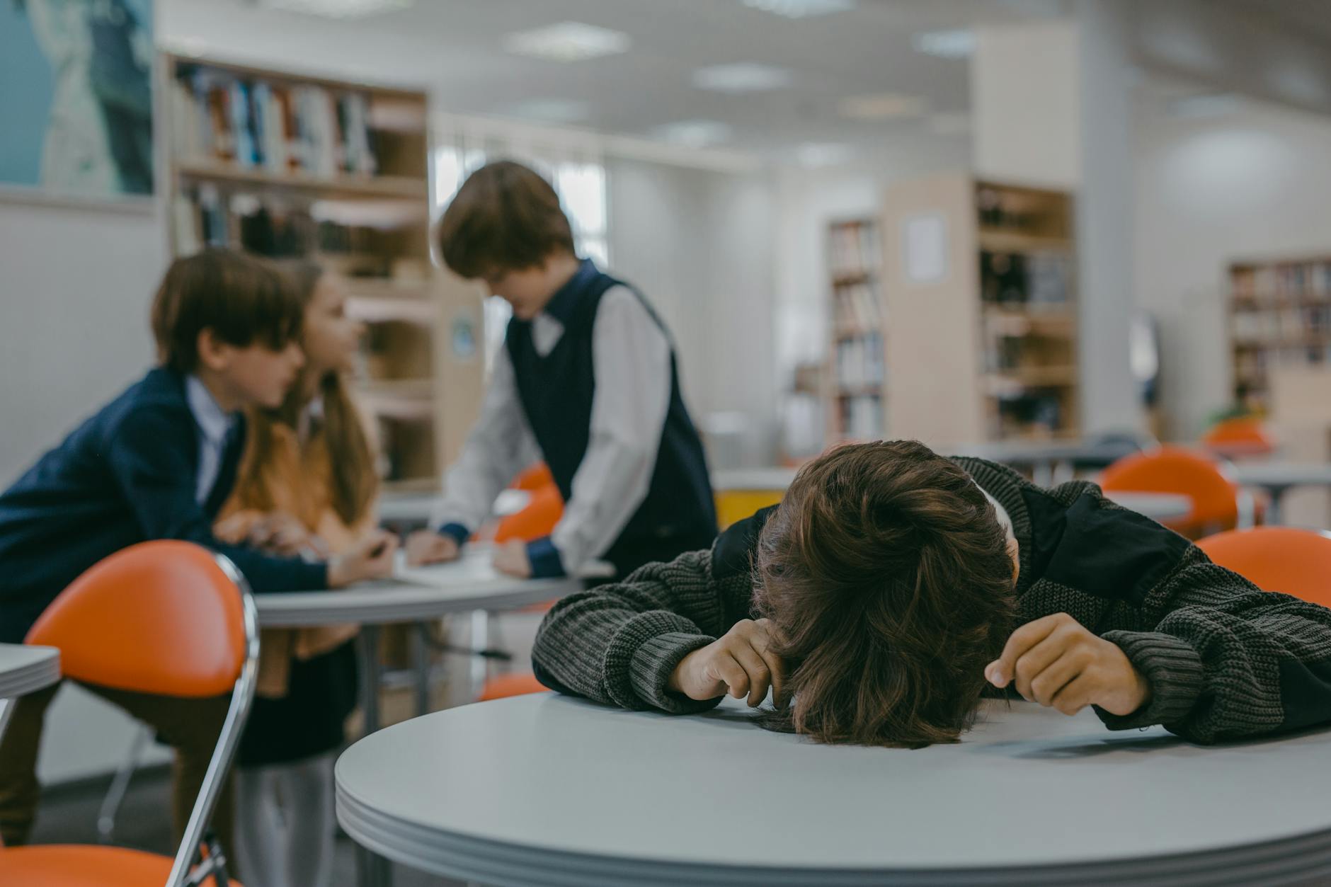 a boy sitting at the table - how autistic masking contributes to burnout