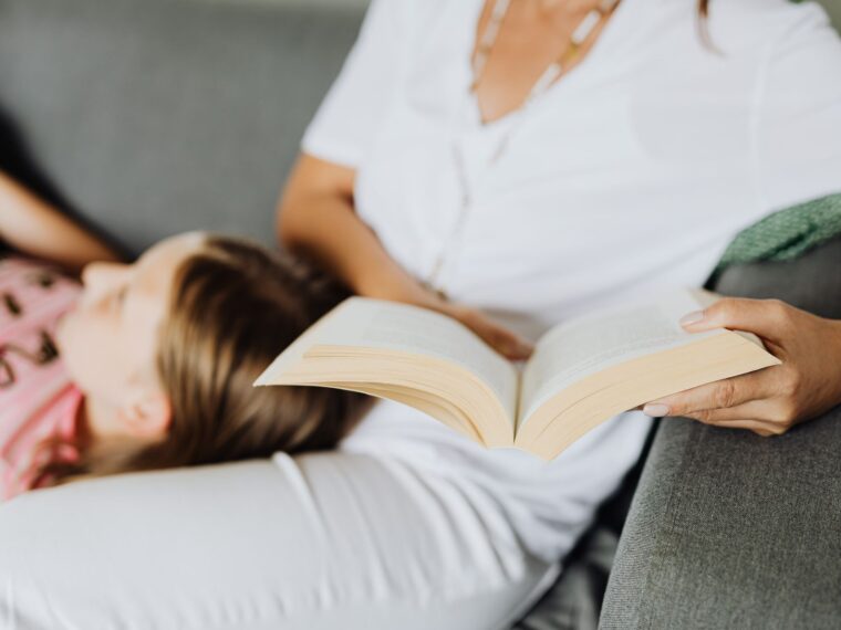 woman in white shirt reading a book