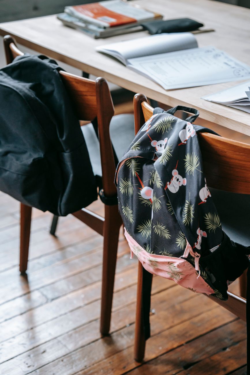 school desk with stationery and backpacks on chairs - acute burnout in autistic children